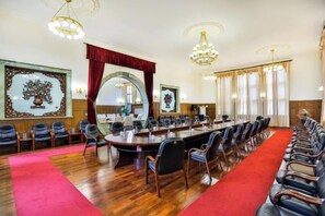 A conference room with a long table, multiple chairs, and a red carpet. - Dongshan Hotel (Anshan)