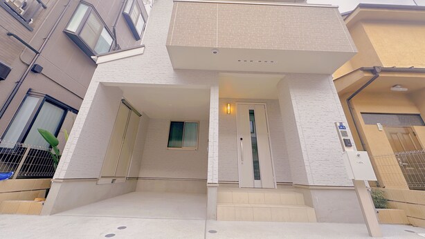 Un immeuble d’appartements moderne, doté d’une façade plane, de grandes fenêtres et d’une entrée bien visible, avec des marches menant à la porte.