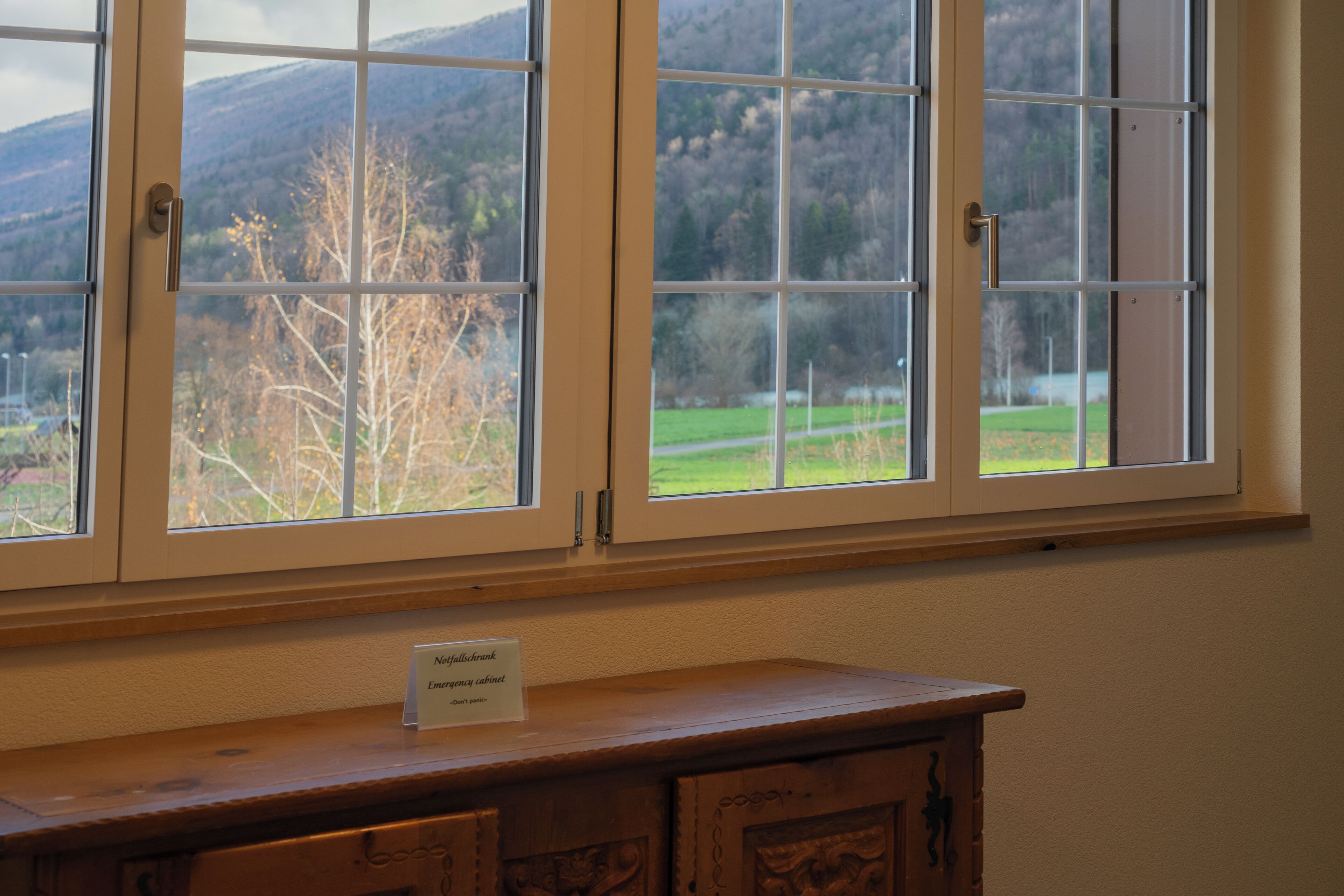 A window with a view of a mountainous landscape.