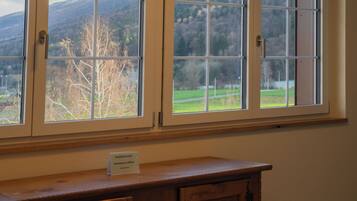 A window with a view of a mountainous landscape.