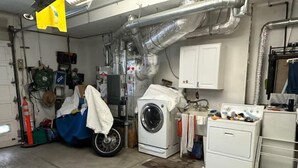 A laundry room with a washing machine, dryer, and ironing station. - Large Private Level 2-bedroom Garden en-suite San Francisco (San Francisco)