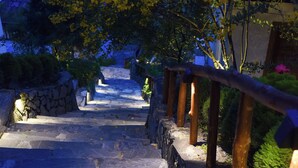A stone staircase leading up to a building with a wooden railing. - 4-bedroom resort in terrific Lao Cai with WiFi, AC (Lao Cai)