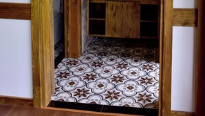 A bathroom with a wooden archway, a sink with a mirror, and patterned floor tiles. - 4-bedroom resort in terrific Lao Cai with WiFi, AC (Lao Cai)