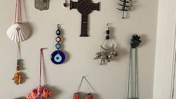 A variety of wall hangings including crosses, a hand, and decorative items.