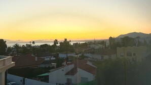 A residential area with houses, a body of water, and a mountain in the background. - Bright 'Luminoso Marbella' Apartment with Sea Views, Wi-Fi and Air Conditioning (Marbella)