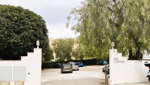 A gated entrance with parked cars, a sign reading 'EDF LINDASOL,' and a large tree. - Bright 'Luminoso Marbella' Apartment with Sea Views, Wi-Fi and Air Conditioning (Marbella)
