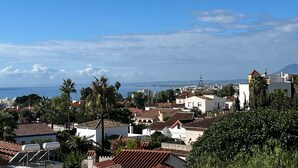 A coastal town with buildings, palm trees, and a clear sky. - Bright 'Luminoso Marbella' Apartment with Sea Views, Wi-Fi and Air Conditioning (Marbella)