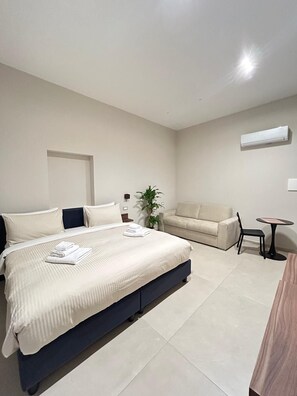 Comfort Quadruple Room, 1 King Bed with Sofa bed | Down comforters, pillowtop beds, in-room safe, laptop workspace