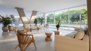 A spacious lobby with modern furniture, large windows, and indoor plants. - Private luxury jacuzzi in Pozos Colorados (Magdalena)