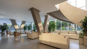 A spacious lobby with modern furniture, large windows, and a unique architectural design with prominent beams. - Private luxury jacuzzi in Pozos Colorados (Magdalena)