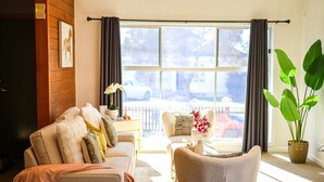 A living room with a sofa, armchairs, and a large window with curtains. - StayAU Private Two-Storey 6 Beds House Wendouree (Wendouree)