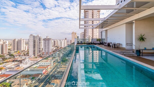 A rooftop infinity pool with a city view, modern architecture, and outdoor seating. - Incredible Stay With Pool and gym in Setor Bueno - Dnag (Goiânia)