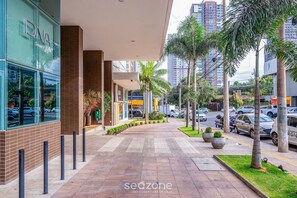 A modern building with a glass facade and a brick base, featuring a sign that reads "DNA Smart Home."