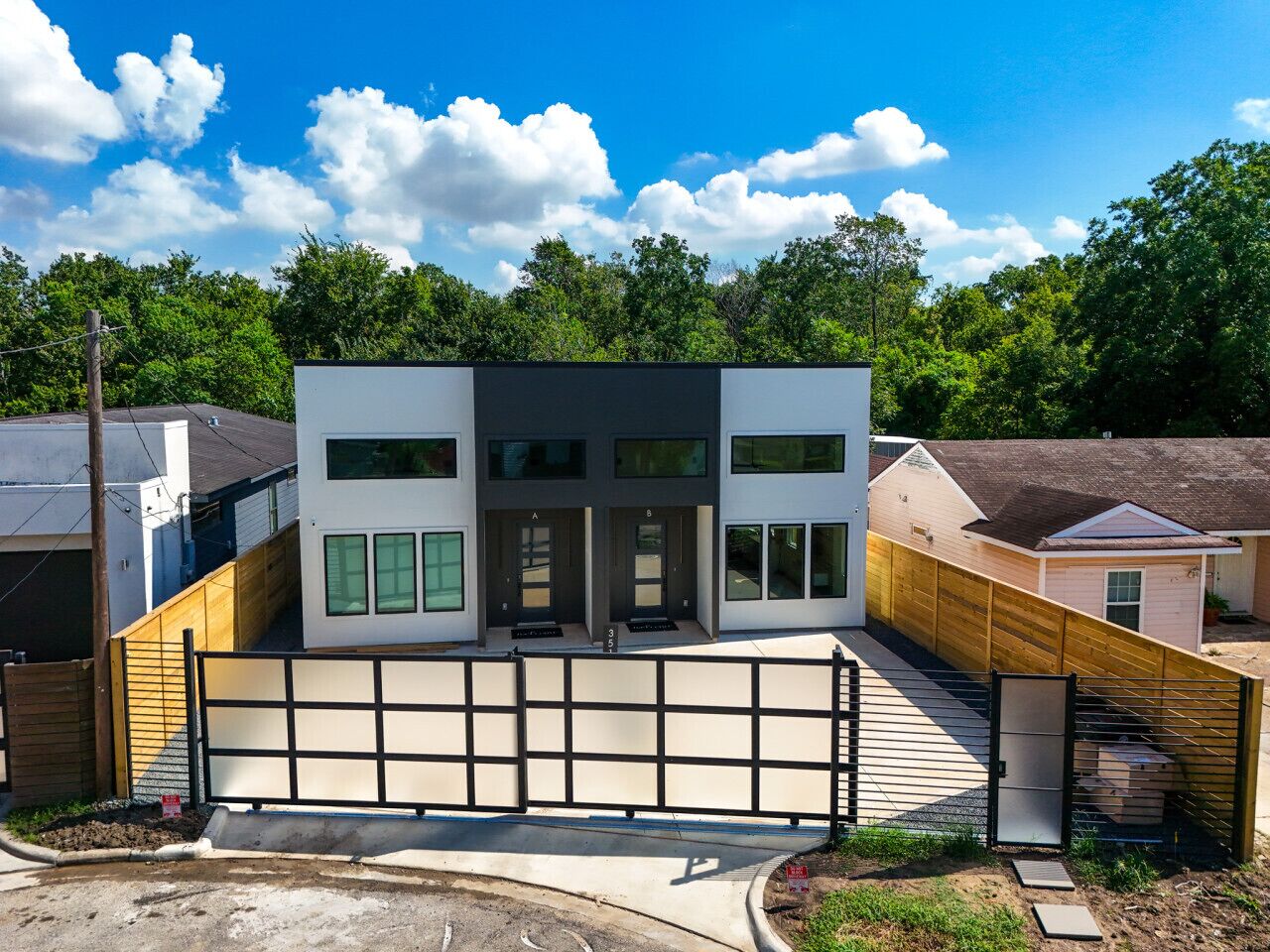 A modern two-story house with a large garage and a covered driveway.