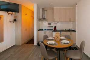 Fridge, microwave, coffee/tea maker, cookware/dishes/utensils