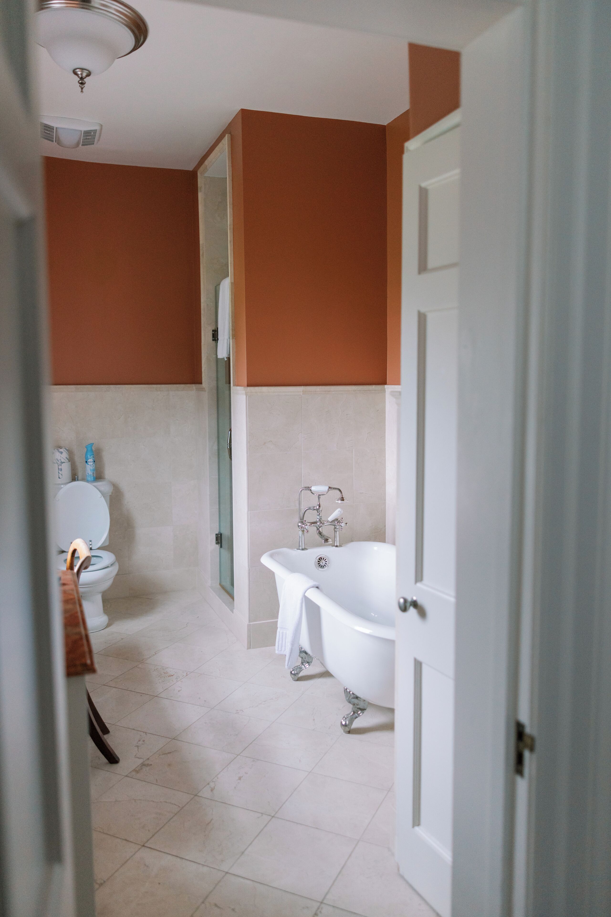 A bathroom with a toilet, a bathtub, and a shower.