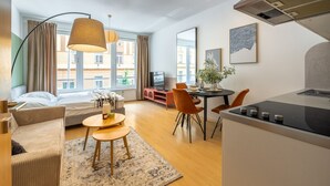 A modern apartment with a living area, dining space, and kitchenette. - Designer Prague Studio in a Vibrant Neighborhood by EasyBNB Premium (Prague)