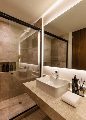 A modern bathroom with a large mirror, a freestanding sink, and a walk-in shower. - K'Abax Jungle Apartment Beach Club Access (Tulum)