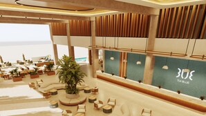 A spacious lobby with a central seating area, a large potted plant, and a reception desk with a 'TUI BLUE' sign. - TUI BLUE Curacao All Inclusive (Soto)