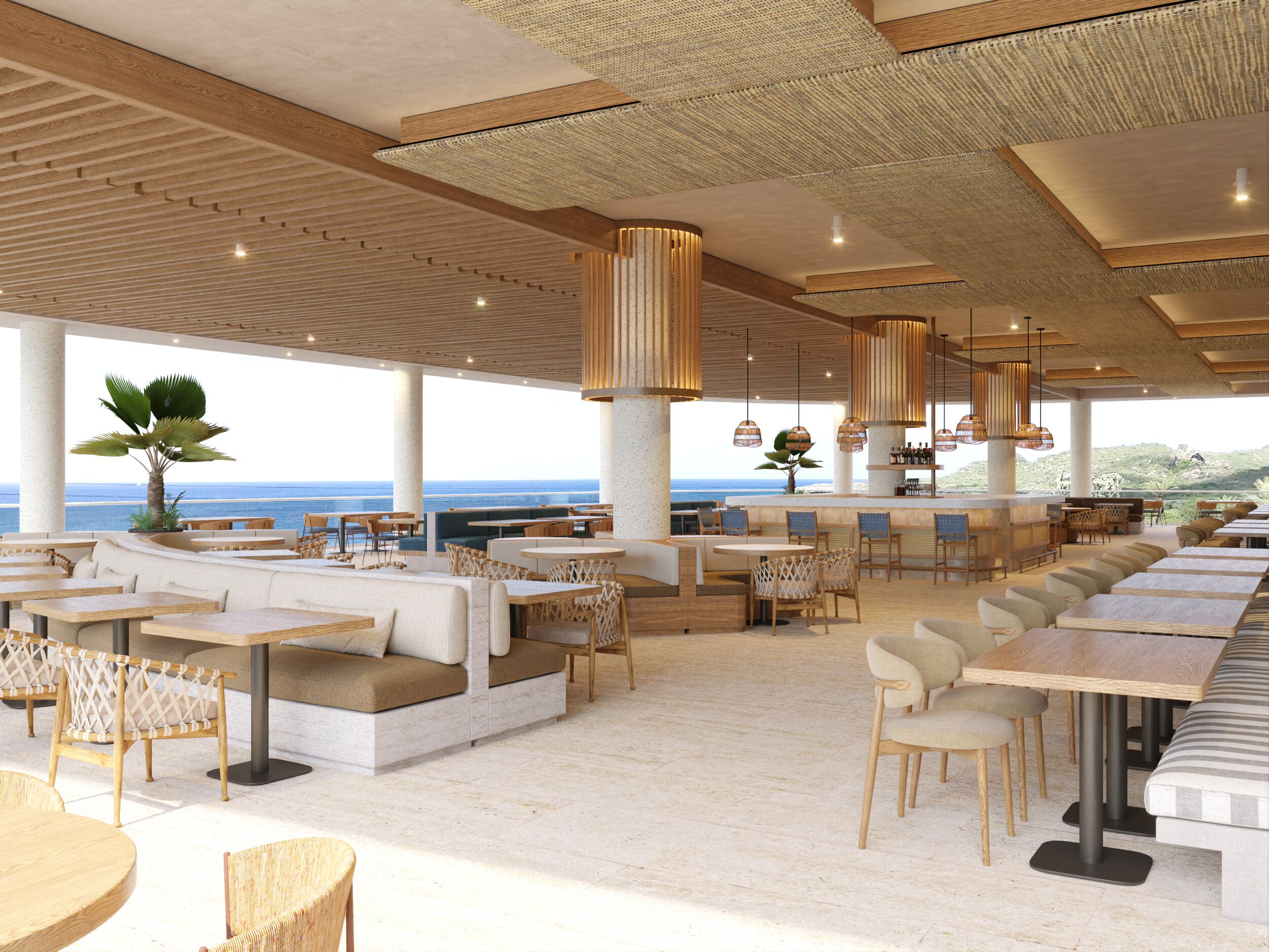Een ruim buitenterras met diverse zitmogelijkheden, zoals tafels en comfortabele banken, met uitzicht op een prachtig landschap.