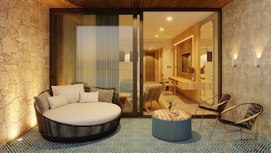A modern bedroom with a large bed, a seating area with chairs, and a bathroom visible through a glass door. - TUI BLUE Curacao All Inclusive (Soto)