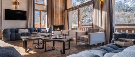 Télévision, cheminée, lecteur de DVD, baby-foot