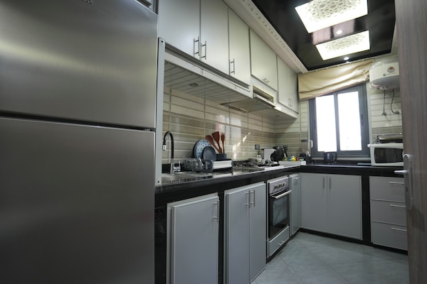 Luxury Apartment, Patio, Garden View | Private kitchen | Full-size fridge, microwave, oven, stovetop