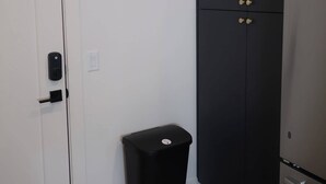 A room with a white door, a black trash bin, a black wardrobe, and a stainless steel refrigerator. - Cozy studio in marvelous Salt Lake City with WiFi, AC (Salt Lake City)