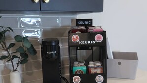 A kitchen with a Keurig coffee maker and a coffee pod holder. - Cozy studio in marvelous Salt Lake City with WiFi, AC (Salt Lake City)