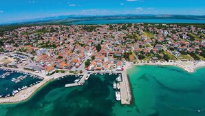 An aerial view of a coastal town with a marina, residential buildings, and a beach. - Stunning apartment in Pakostane with WiFi (Pakostane)