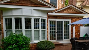 A two-story house with a large bay window and a covered patio area. - SPRING LAKER 6 bedroom wrap around porch 2 blocks to beach 1 block  to town (Spring Lake)