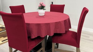 A conference room with a round table, red upholstered chairs, and a potted plant on the table. - 
Cozy guest suite, walking trails (Calgary)