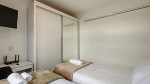 A hotel room with a bed, a desk with a computer, and a mirror. - Comfortable Apartment, Lago Norte Bvt0418 (Lago Norte)