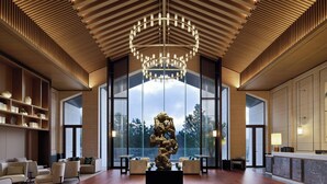 A spacious lobby with a modern chandelier, large windows, and a central sculpture. -  长兴开元名都臻品之选度假酒店 (Huzhou)