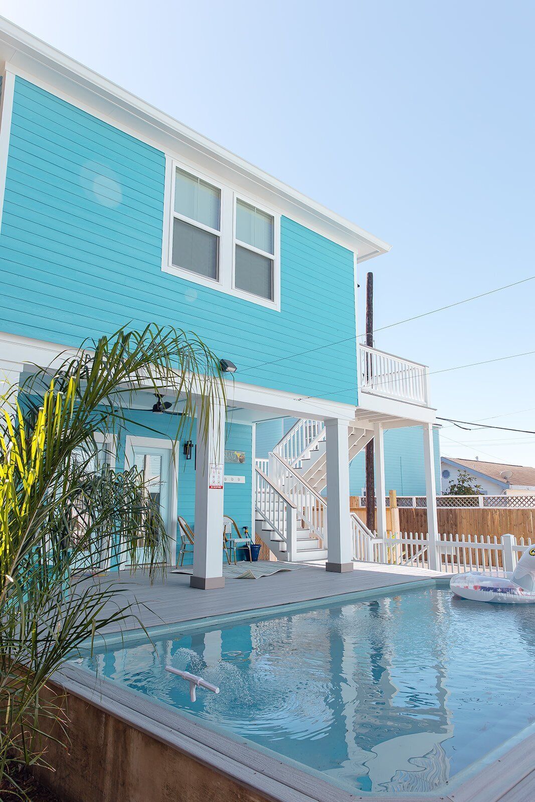 A two-story building with a pool in front.