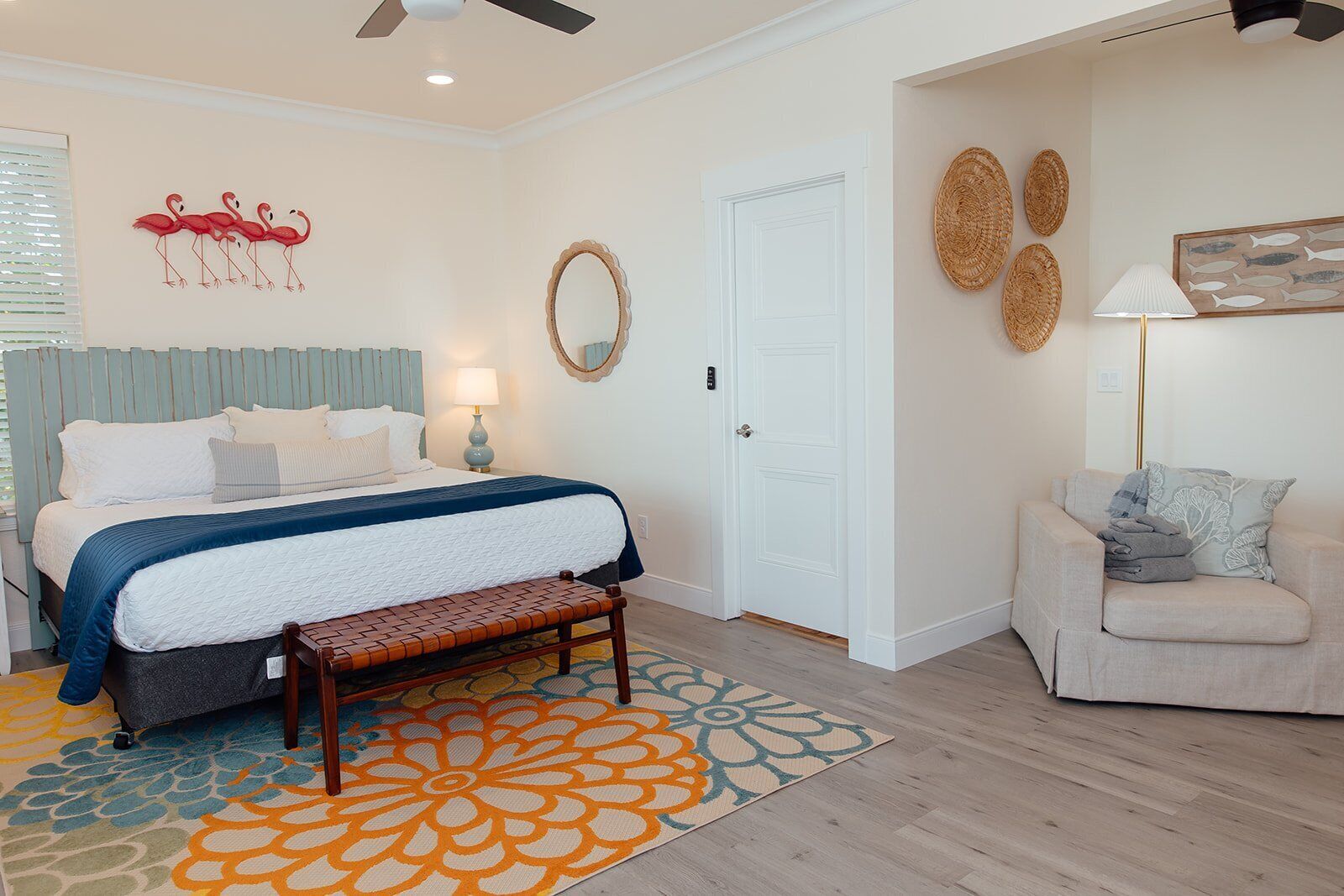 A bedroom with a bed, bench, and a sofa.