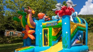 An inflatable play structure with a slide and various animal figures. - Apartment on Lake Serre-poncon With Pool (Chorges)