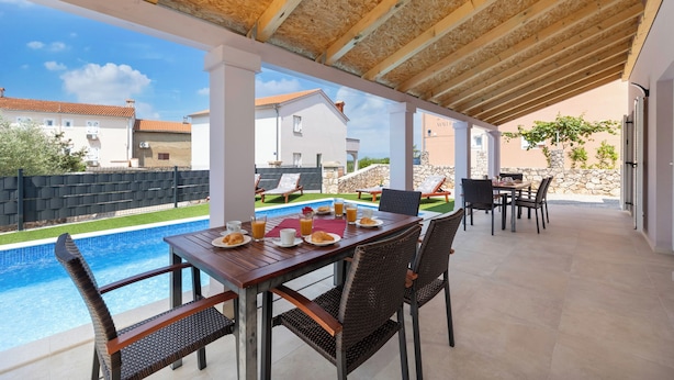 An outdoor patio with a pool, dining table, and chairs. - Villa Stjepan Zep (Kvarner - Županje) (Županje)