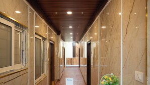 A corridor with a wooden desk, a laptop, and a basket of lemons. - Anand's Abode By Yellow Bells (Hyderabad)