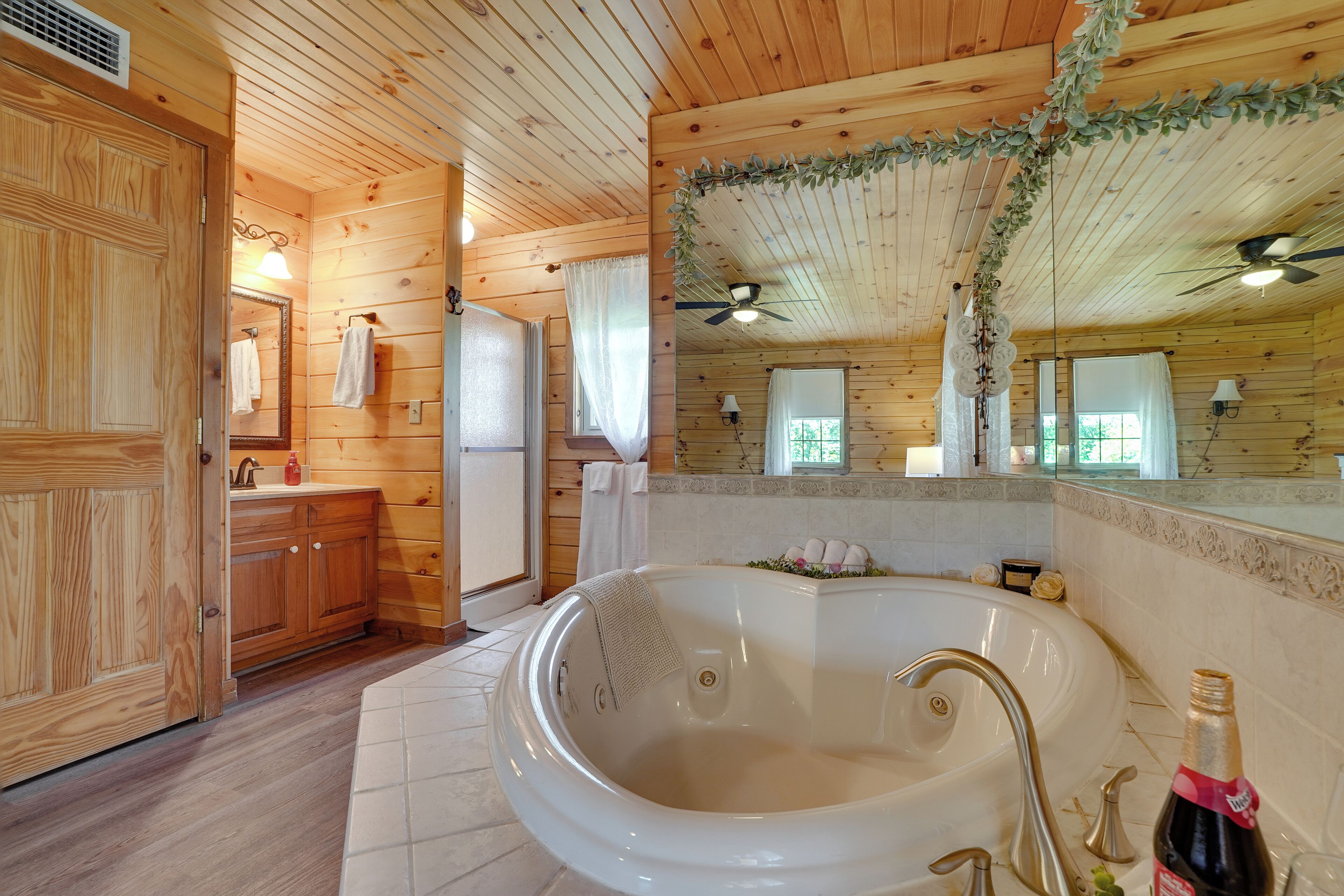 Full bath with Heart Shaped Jetted Tub, standing shower, and a sink vanity.