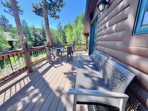 A wooden deck with a table and chairs, a bench, and a railing. - Aspen Hollow Lodge w/ Hot Tub + Fire Pit (Frisco)