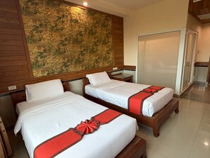 A hotel room with two beds, a wooden headboard, a map on the wall, and a sliding door. - Sunday Grand Jomtien Pattaya (Pattaya)
