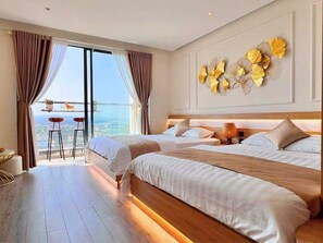 Deluxe Quadruple Room, Balcony, Sea View | Hypo-allergenic bedding, in-room safe, desk, laptop workspace