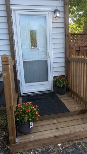 A wooden deck with a door, a potted plant, and a welcome mat. - (NOT available yet)
ESTATE: RARE 6BR PLUS 2BR/ total 3Bath and 2 kitchen (Sault Ste. Marie)