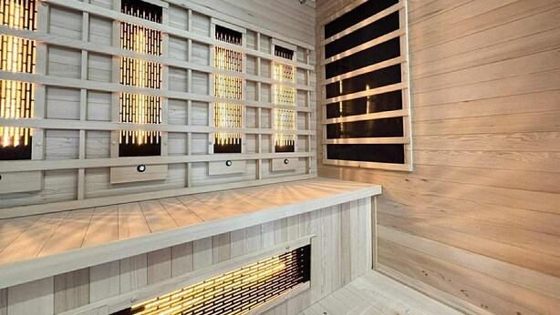 Un intérieur moderne avec un mur en bois, des étagères intégrées, un banc et une cheminée.