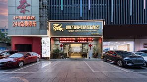 A hotel entrance with a sign for Qida Fashion Boutique Hotel. - Qidajiudian (Deyang)