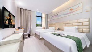 A hotel room with two beds, a desk, a chair, a TV, and a painting on the wall. - Qidajiudian (Deyang)