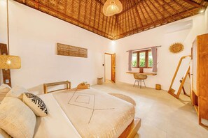 A bedroom with a bed, a desk, a chair, a window, and a door. - Villa Toscana - Huge 7BDR with 3 Pools (Kecamatan Kuta Utara)