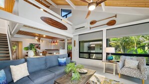 A spacious living area with a blue sofa, a wooden coffee table, and a patterned rug.