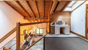 A wooden interior with a kitchen, staircase, and a skylight. - Chalet Abricotine, sleeps 10, Hot tub (Saint-Jean-d´Aulps)